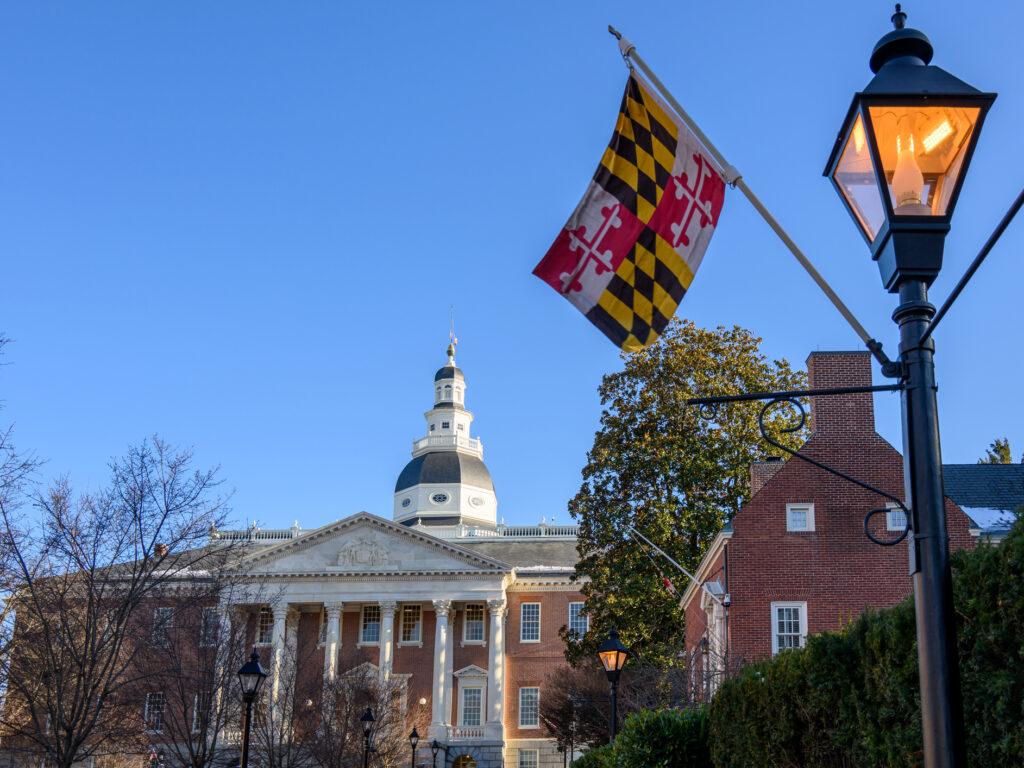 View of the State House of Maryland in Annapolis from Lawyer's Mall. The Maryland state flag hangs from a lamp post in the foreground.